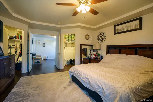 a bedroom with a large bed and a chandelier