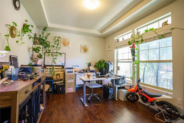 a view of a workspace with furniture and a window