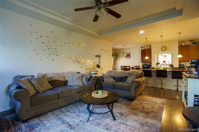 a living room with furniture and a chandelier