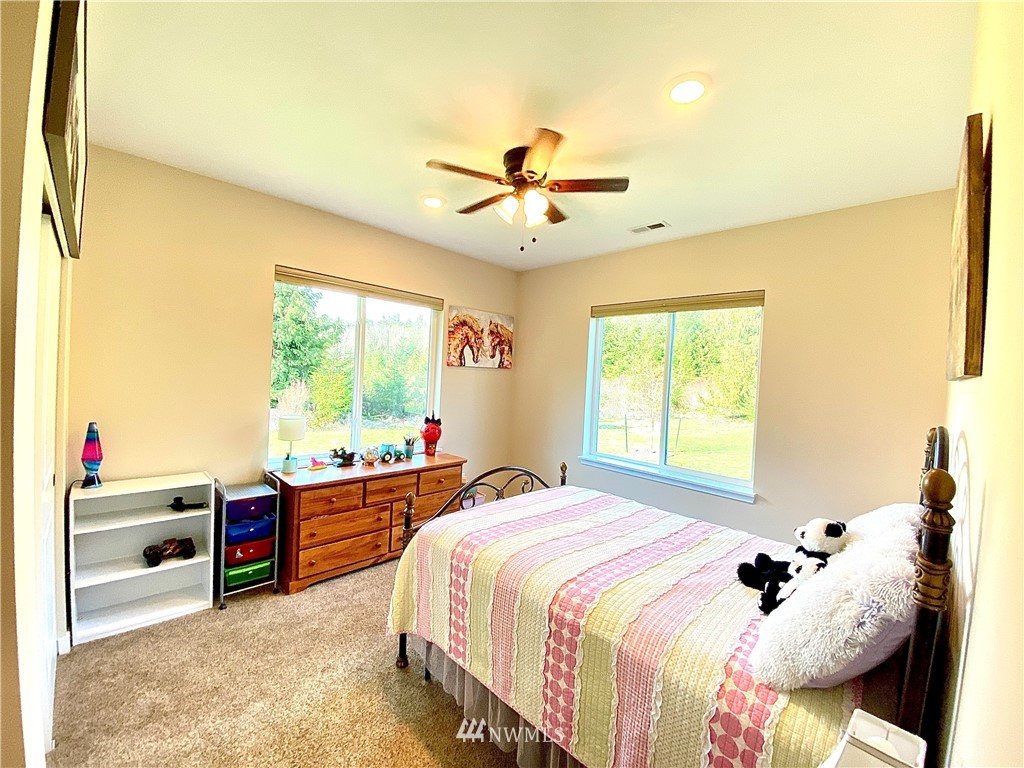22004 Lee Road Southwest Centralia, WA 98531 - Photo 12 of 26 a bedroom with a bed and a chandelier
