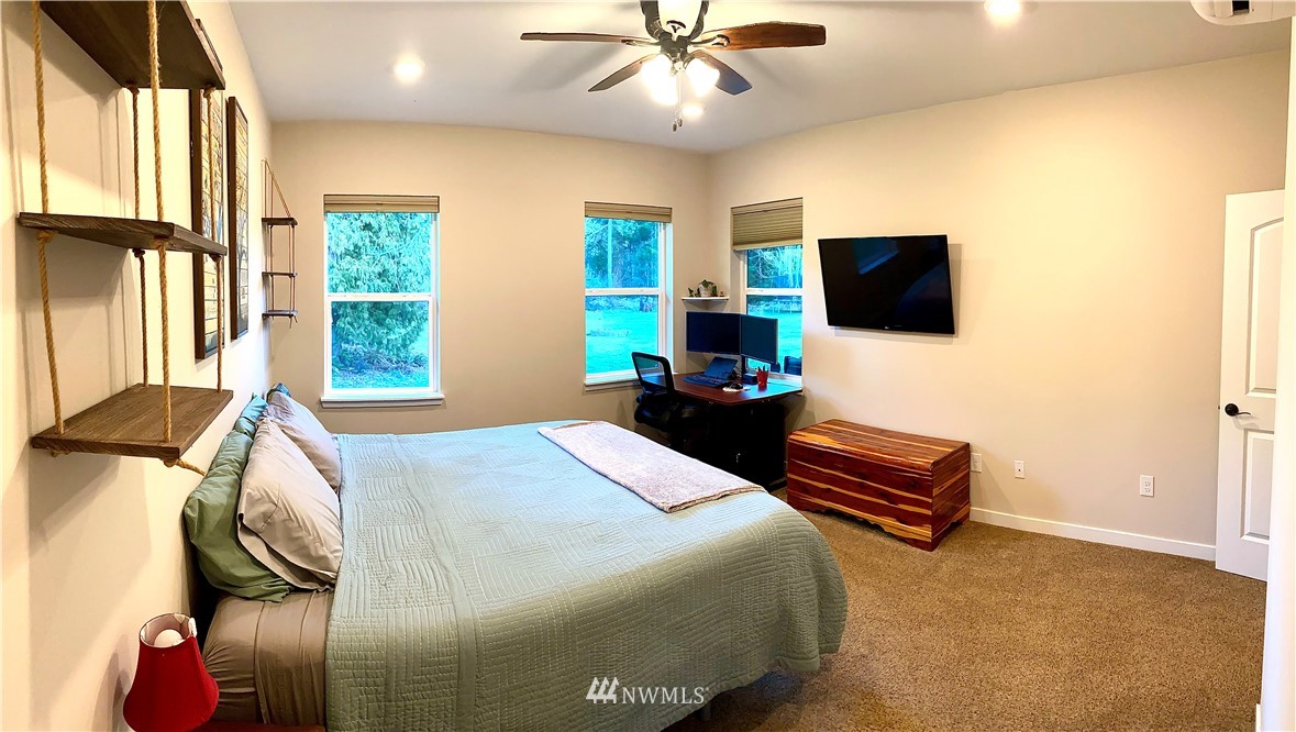 22004 Lee Road Southwest Centralia, WA 98531 - Photo 14 of 26 a bedroom with a bed and a flat screen tv