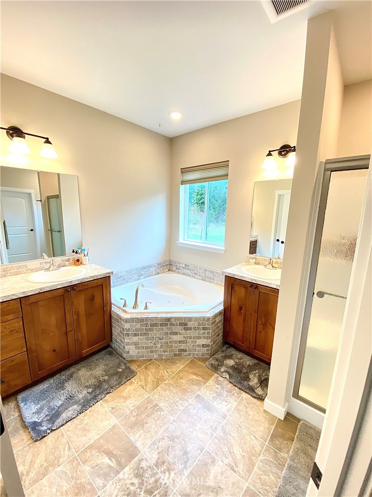 22004 Lee Road Southwest Centralia, WA 98531 - Photo 15 of 26 a spacious bathroom with a tub sink and mirror