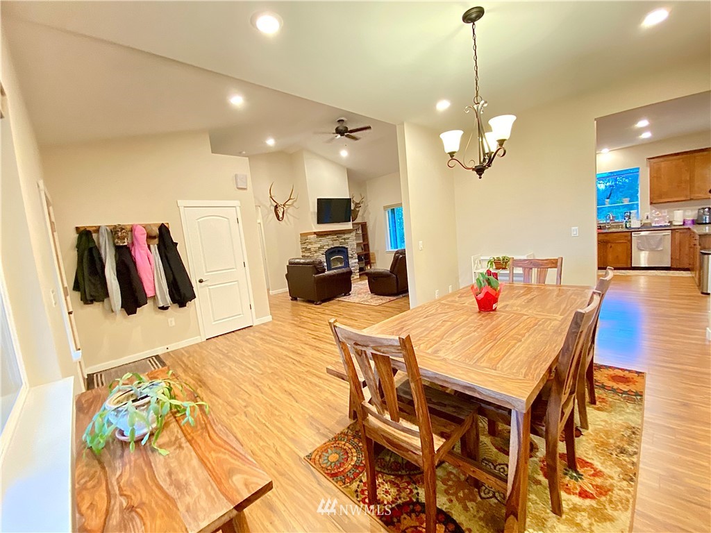 22004 Lee Road Southwest Centralia, WA 98531 - Photo 3 of 26 a very nice looking dining room with kitchen island furniture and a wooden floor