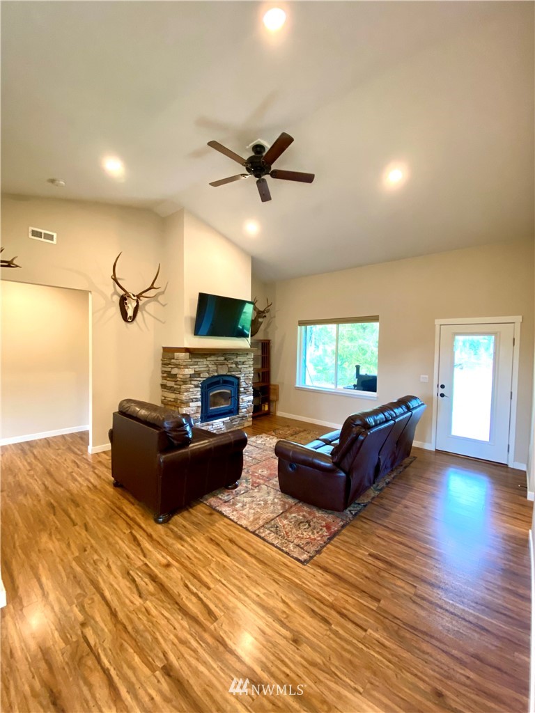 22004 Lee Road Southwest Centralia, WA 98531 - Photo 4 of 26 a living room with furniture flat screen tv and a fireplace