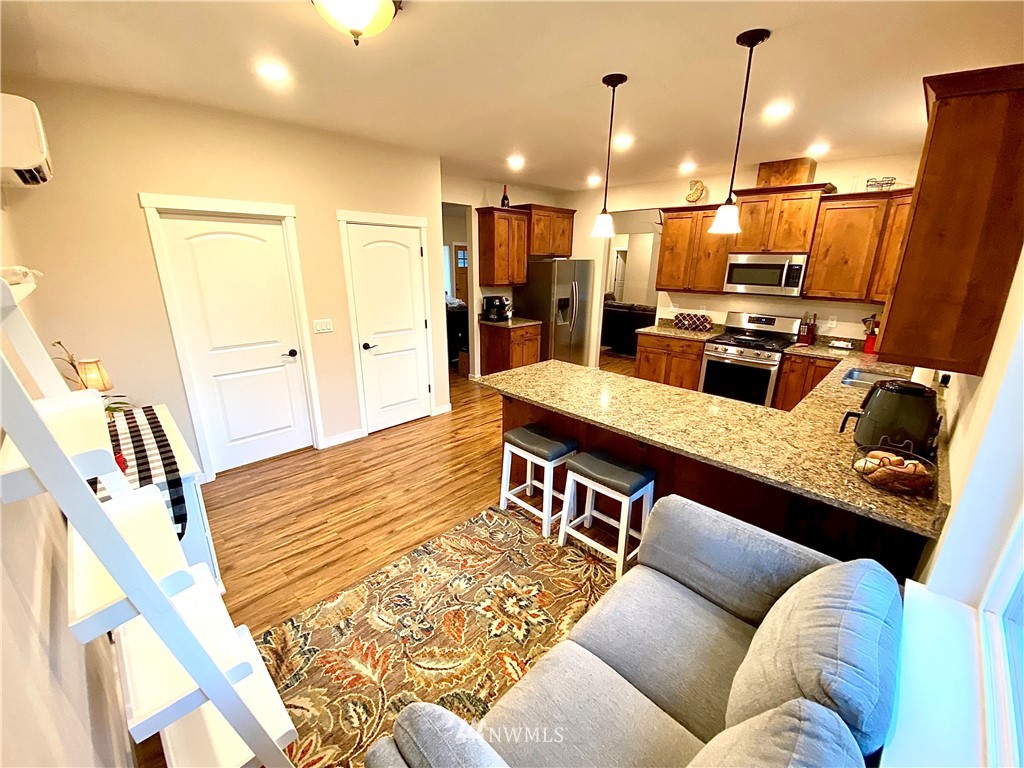 22004 Lee Road Southwest Centralia, WA 98531 - Photo 7 of 26 a living room with furniture kitchen view and a wooden floor