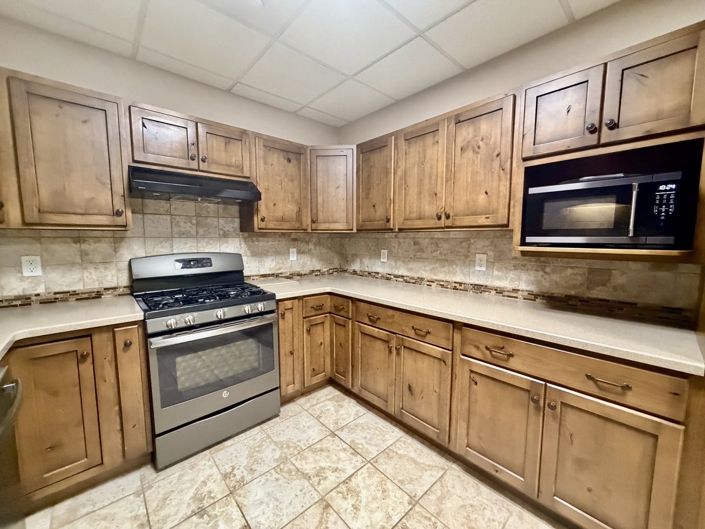 2123 North Avenue Metropolis, IL 62960 - Photo 22 of 49 a kitchen with granite countertop wooden cabinets stainless steel appliances and a window