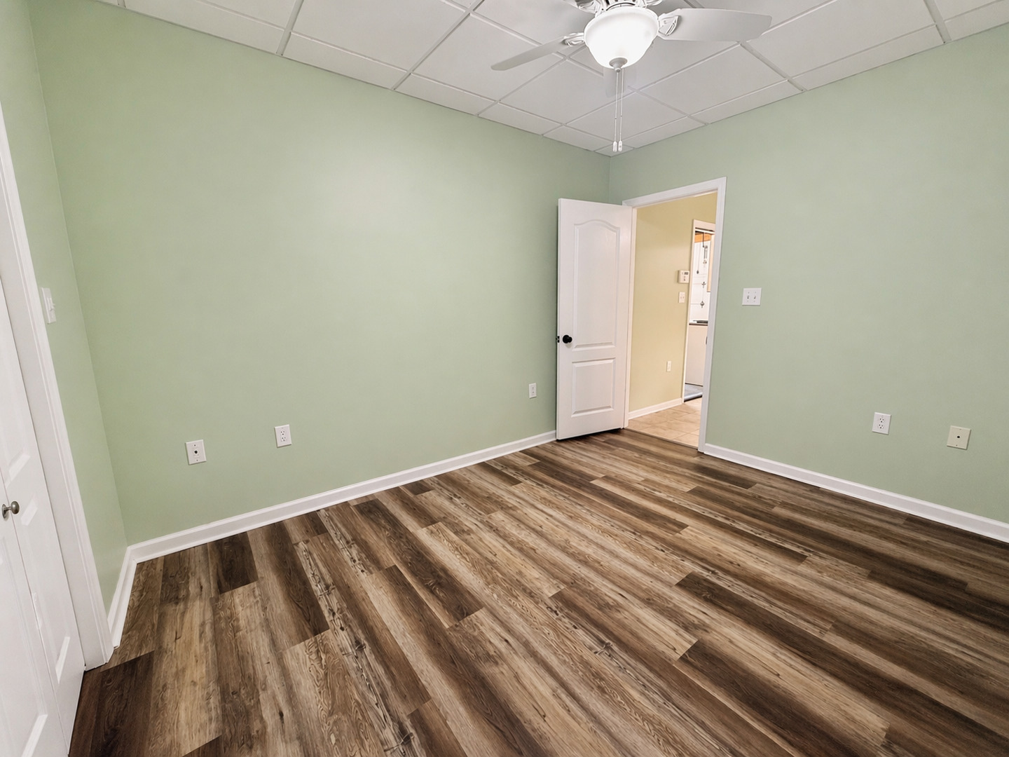 2123 North Avenue Metropolis, IL 62960 - Photo 30 of 49 a view of a room with wooden floor and a ceiling fan