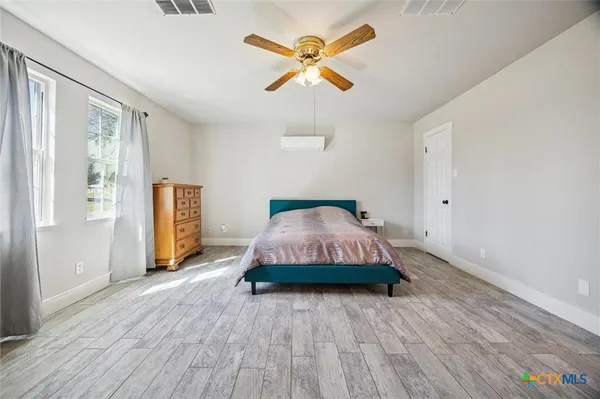 a bedroom with a bed and window