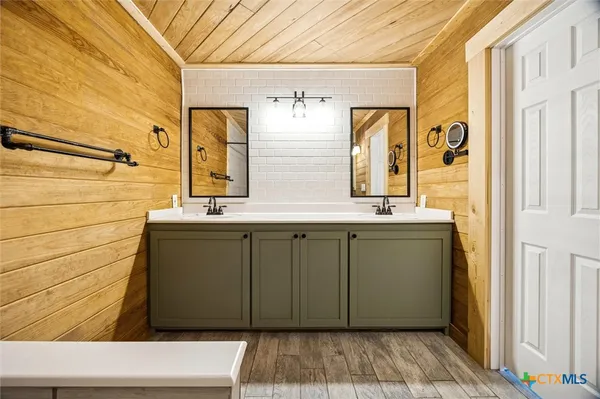 a bathroom with a sink a mirror and shower