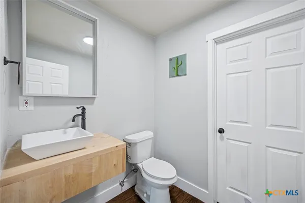 a bathroom with a sink a toilet and a vanity