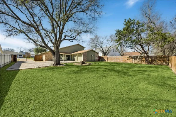a view of house with backyard