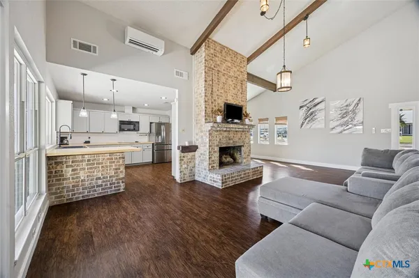 a living room with furniture and a kitchen