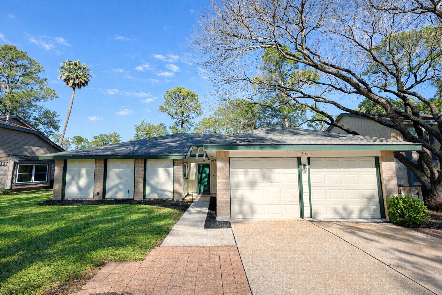 a front view of a house with a garden and plants
