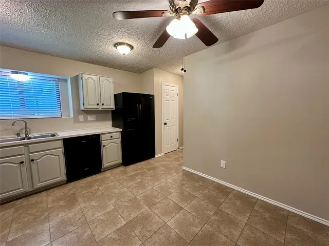 a kitchen with a refrigerator a sink and dishwasher