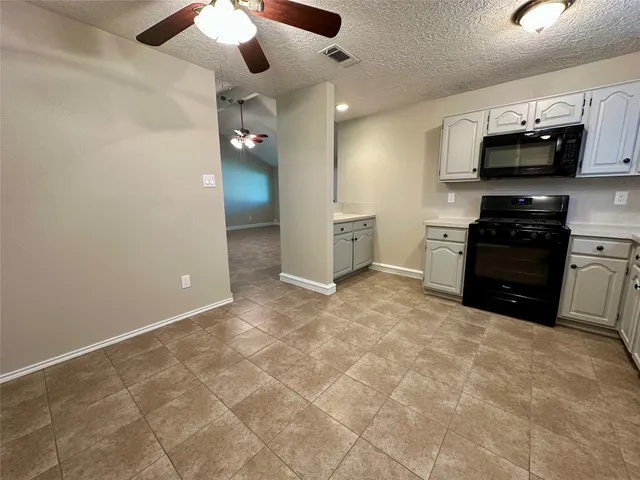 a view of a kitchen with electric appliances