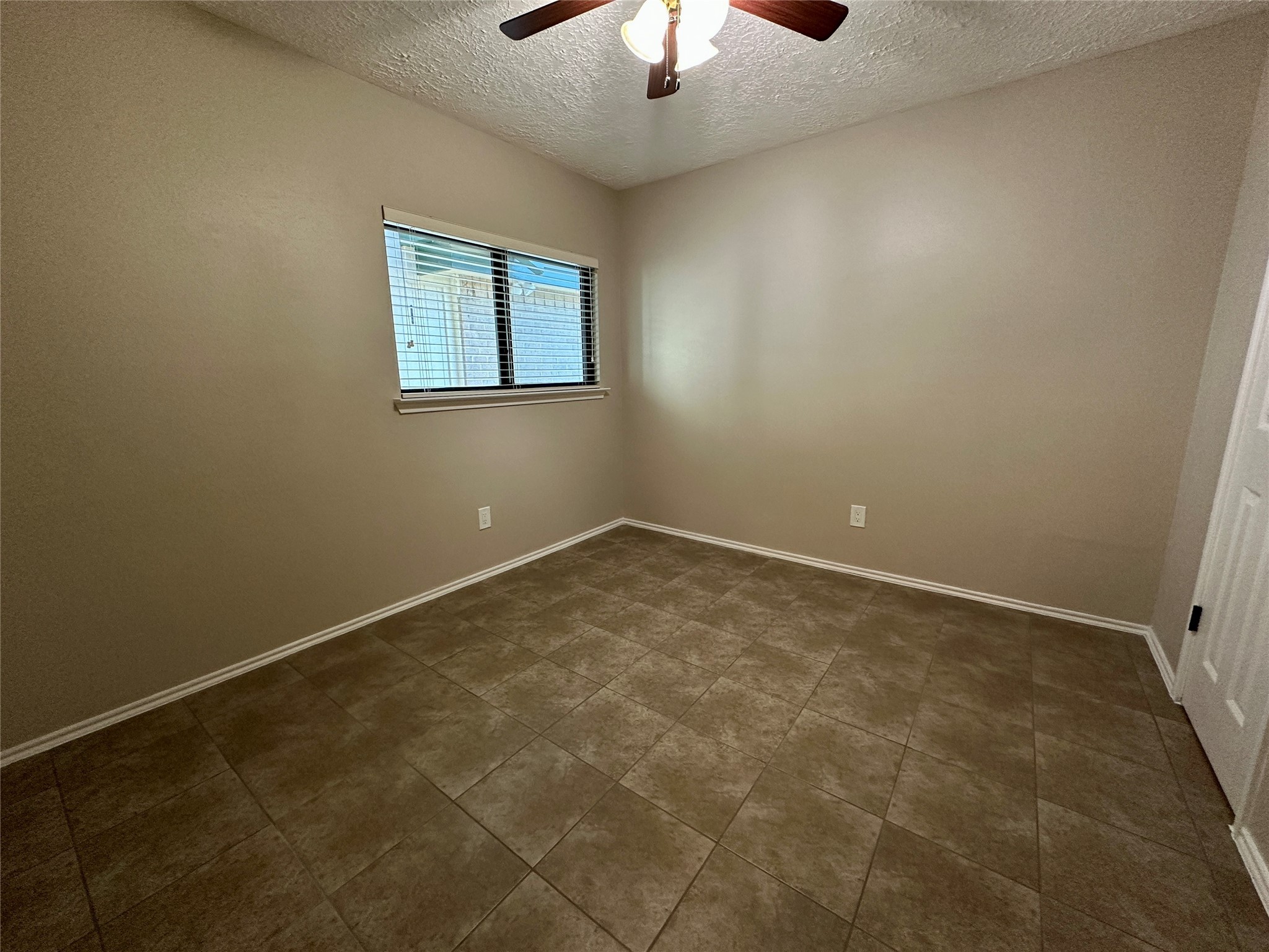 13402 Nevermore Drive Cypress, TX 77429 - Photo 18 of 33 an empty room with a chandelier fan