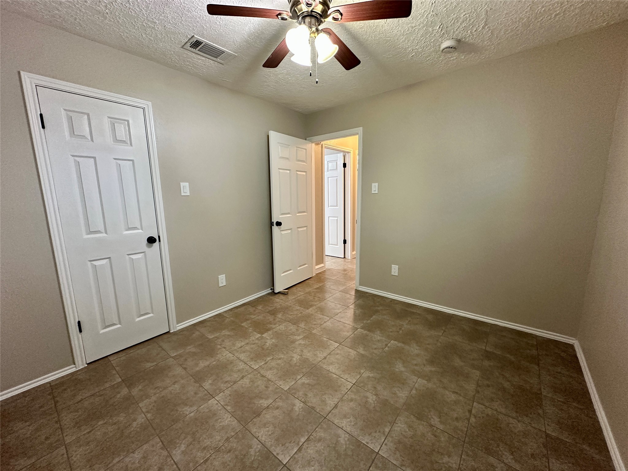 13402 Nevermore Drive Cypress, TX 77429 - Photo 19 of 33 an empty room with a ceiling fan and a rug
