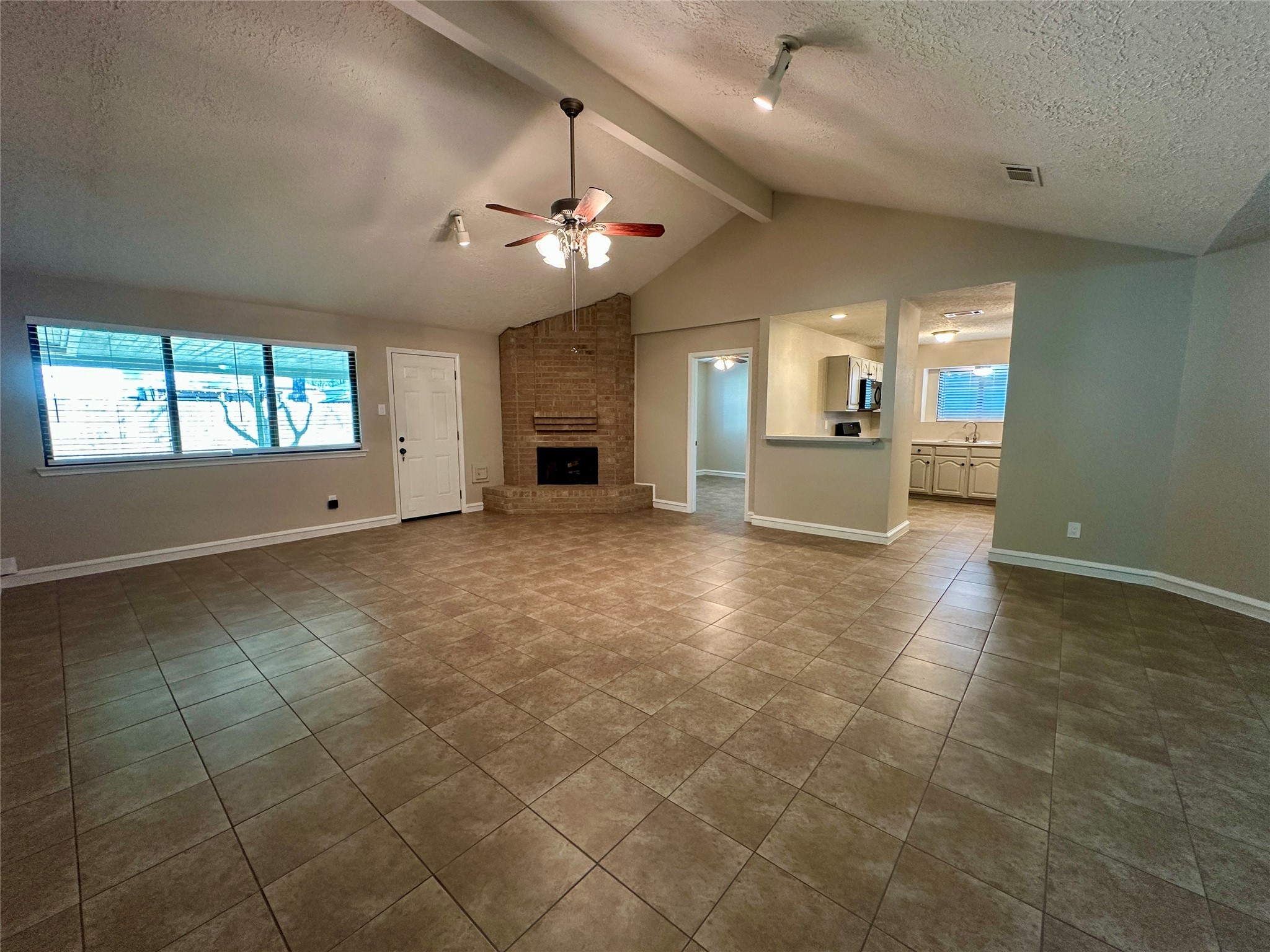 13402 Nevermore Drive Cypress, TX 77429 - Photo 10 of 33 an empty room with a fireplace and chandelier