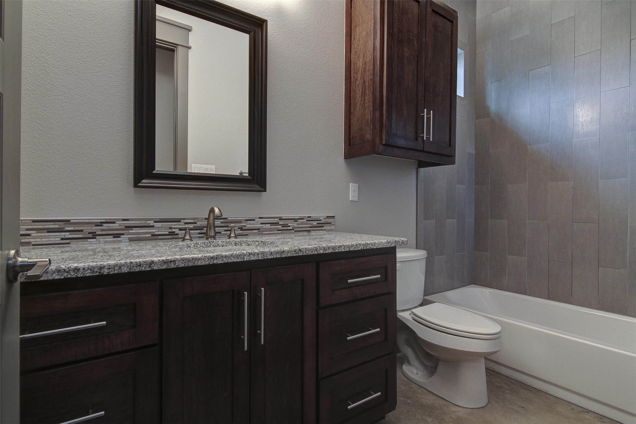 923 East 37th Street Austin, TX 78705 - Photo 19 of 36 a bathroom with a granite countertop toilet sink and mirror