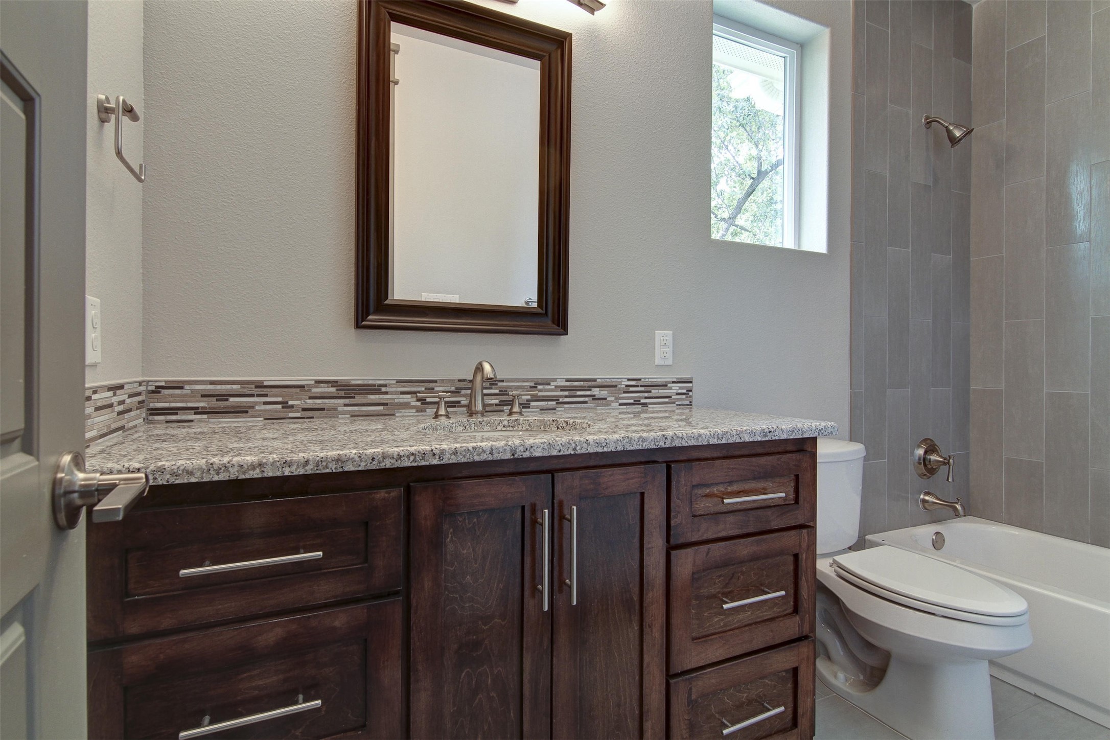 923 East 37th Street Austin, TX 78705 - Photo 25 of 36 a bathroom with a granite countertop toilet sink and mirror