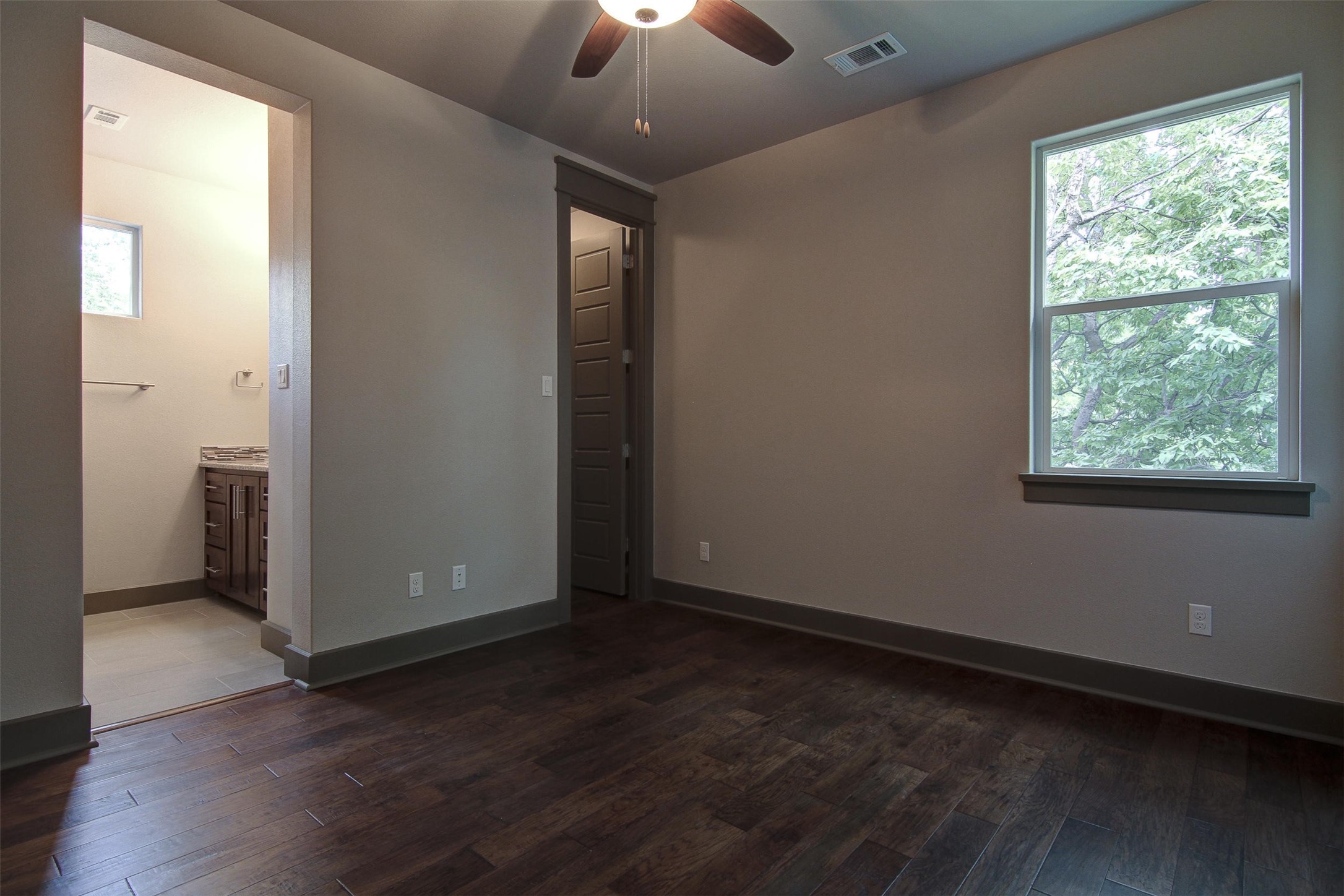 923 East 37th Street Austin, TX 78705 - Photo 28 of 36 an empty room with wooden floor and windows