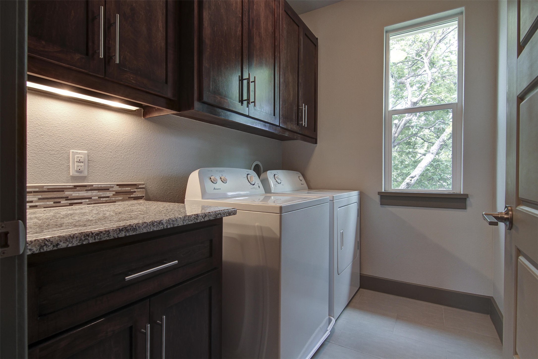 923 East 37th Street Austin, TX 78705 - Photo 30 of 36 a utility room with granite countertop cabinets washer and dryer
