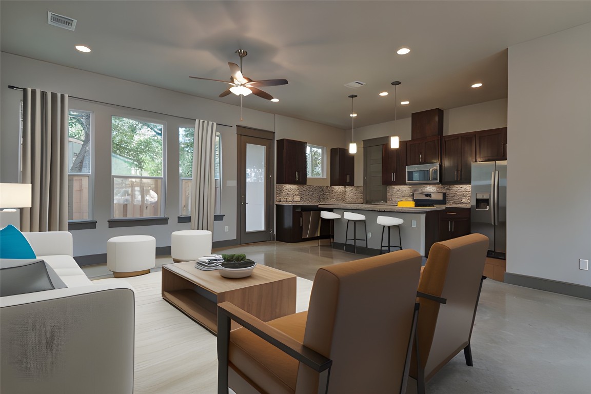923 East 37th Street Austin, TX 78705 - Photo 3 of 36 a dining room with kitchen island furniture a large window and kitchen view