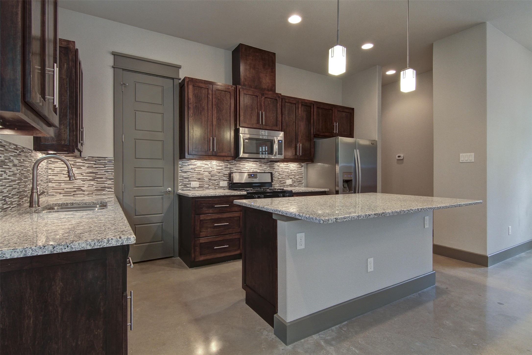 923 East 37th Street Austin, TX 78705 - Photo 8 of 36 a kitchen with kitchen island granite countertop stainless steel appliances and wooden cabinets
