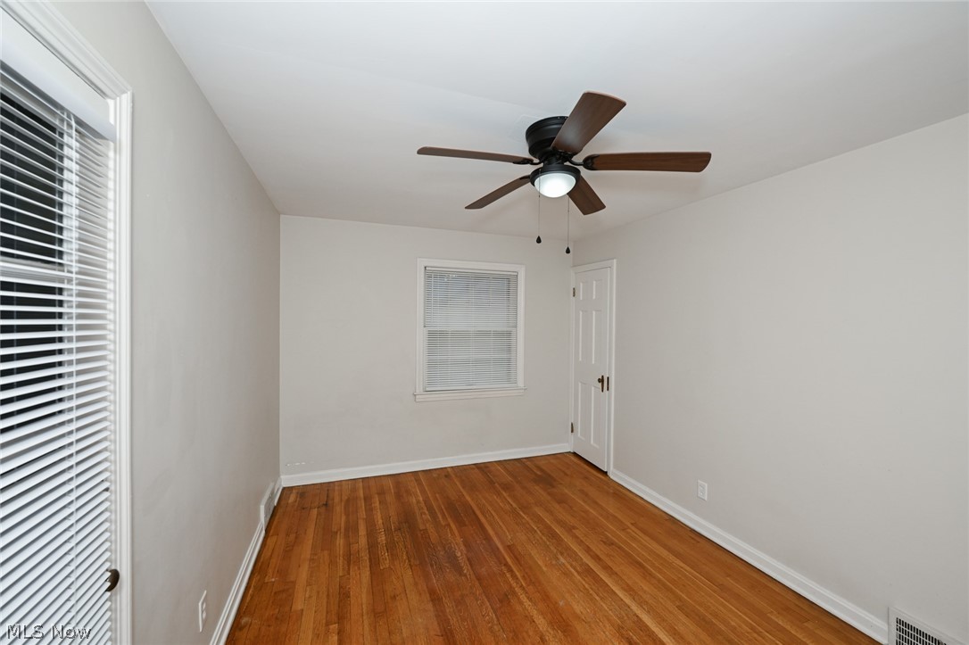 3699 Bainbridge Road Cleveland Heights, OH 44118 - Photo 29 of 37 Hardwood flooring throughout, neutral wall paint, white trim, and a ceiling fan with integrated lighting