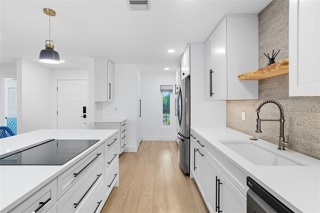 3420 Wild Oak Bay Boulevard, Unit 118 Bradenton, FL 34210 - Photo 14 of 40 a large kitchen with a sink and cabinets