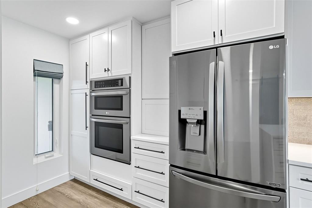 3420 Wild Oak Bay Boulevard, Unit 118 Bradenton, FL 34210 - Photo 15 of 40 a metallic refrigerator freezer sitting in a kitchen