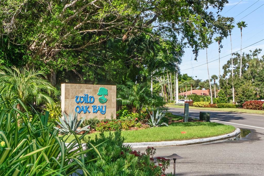 3420 Wild Oak Bay Boulevard, Unit 118 Bradenton, FL 34210 - Photo 2 of 40 a sign on the side of the road