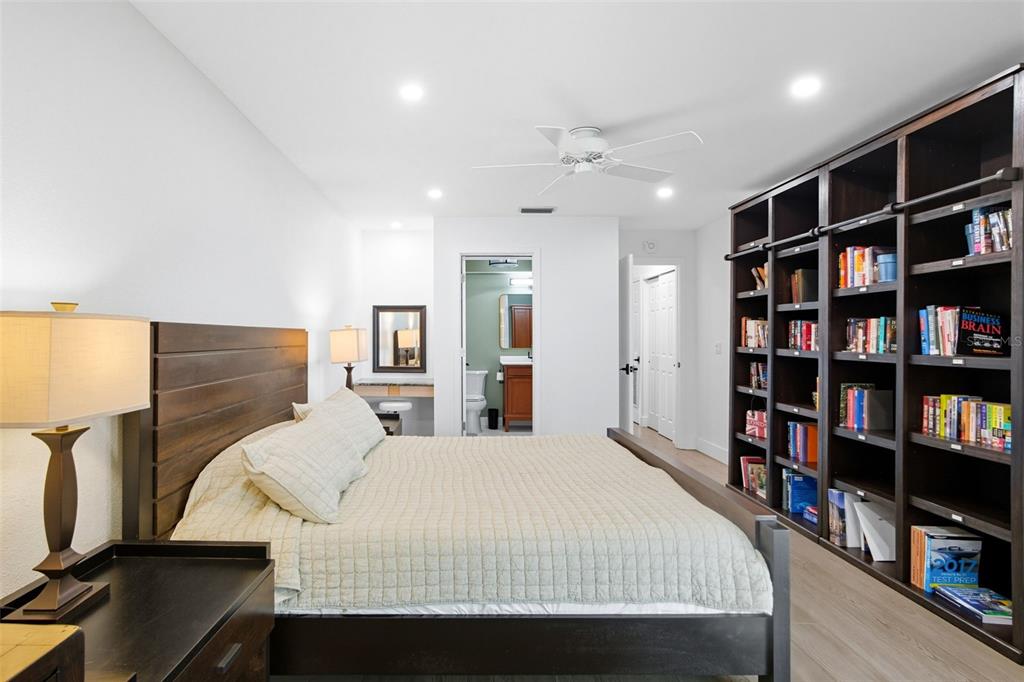 3420 Wild Oak Bay Boulevard, Unit 118 Bradenton, FL 34210 - Photo 24 of 40 a bedroom with a bed furniture and a book shelf