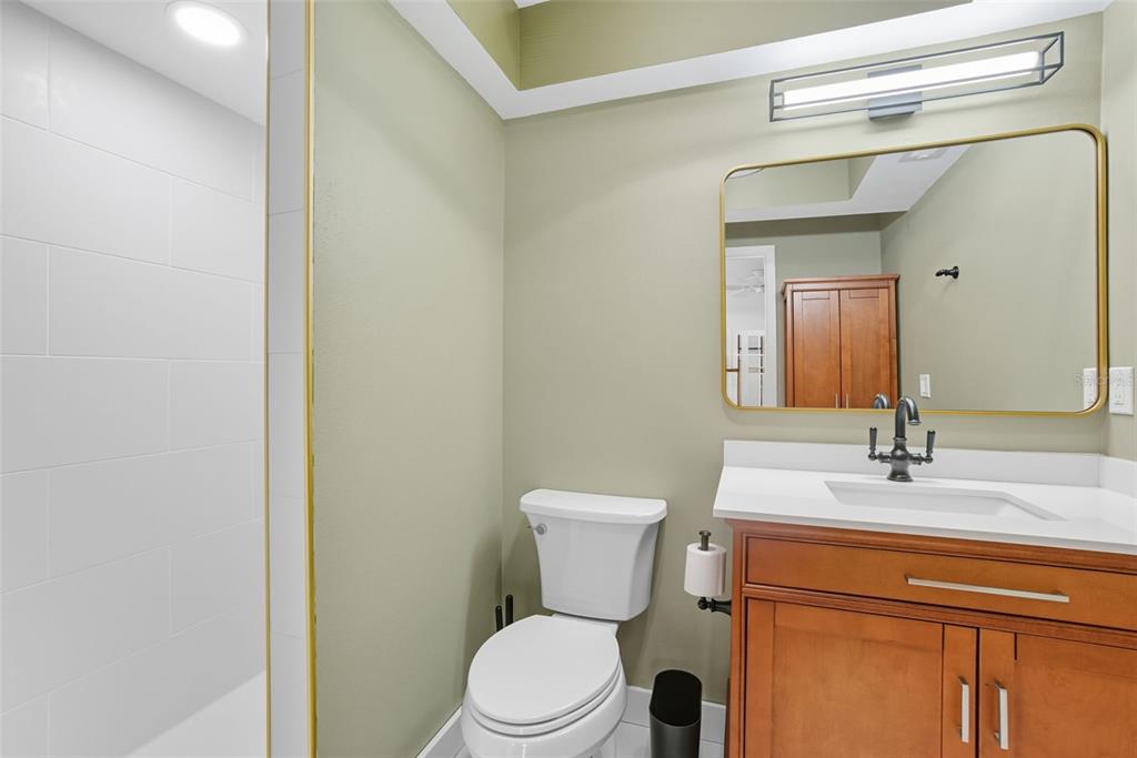 3420 Wild Oak Bay Boulevard, Unit 118 Bradenton, FL 34210 - Photo 26 of 40 a bathroom with a toilet a sink and mirror