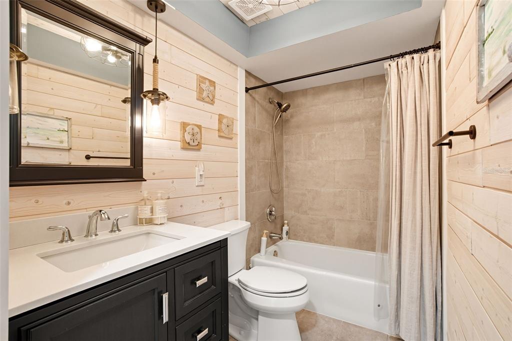 3420 Wild Oak Bay Boulevard, Unit 118 Bradenton, FL 34210 - Photo 27 of 40 a bathroom with a sink a toilet a mirror and shower