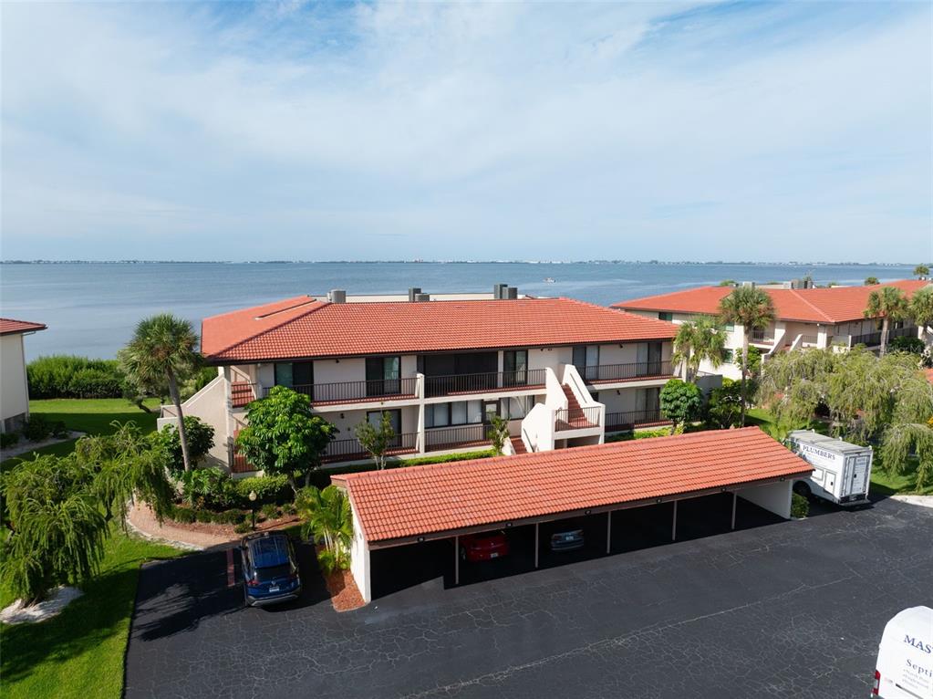 3420 Wild Oak Bay Boulevard, Unit 118 Bradenton, FL 34210 - Photo 3 of 40 a outdoor sitting area with a table and chairs under an umbrella