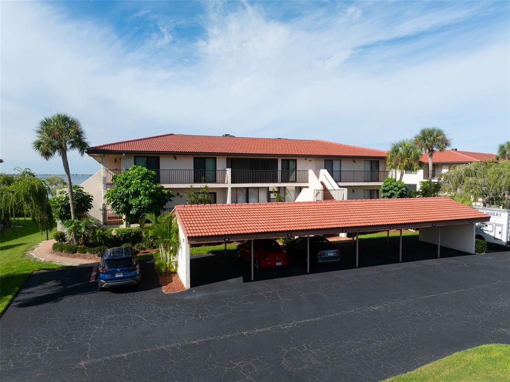 3420 Wild Oak Bay Boulevard, Unit 118 Bradenton, FL 34210 - Photo 34 of 40 a front view of a house with a yard and garage