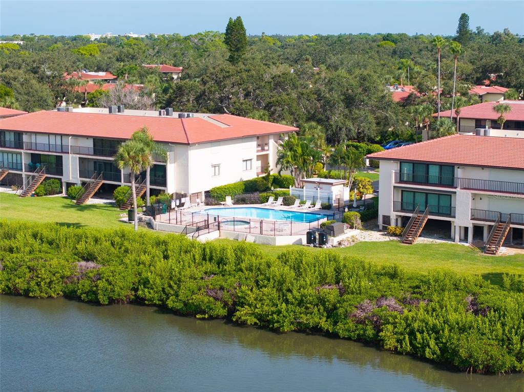 3420 Wild Oak Bay Boulevard, Unit 118 Bradenton, FL 34210 - Photo 36 of 40 a view of a house with pool lawn chairs and a yard