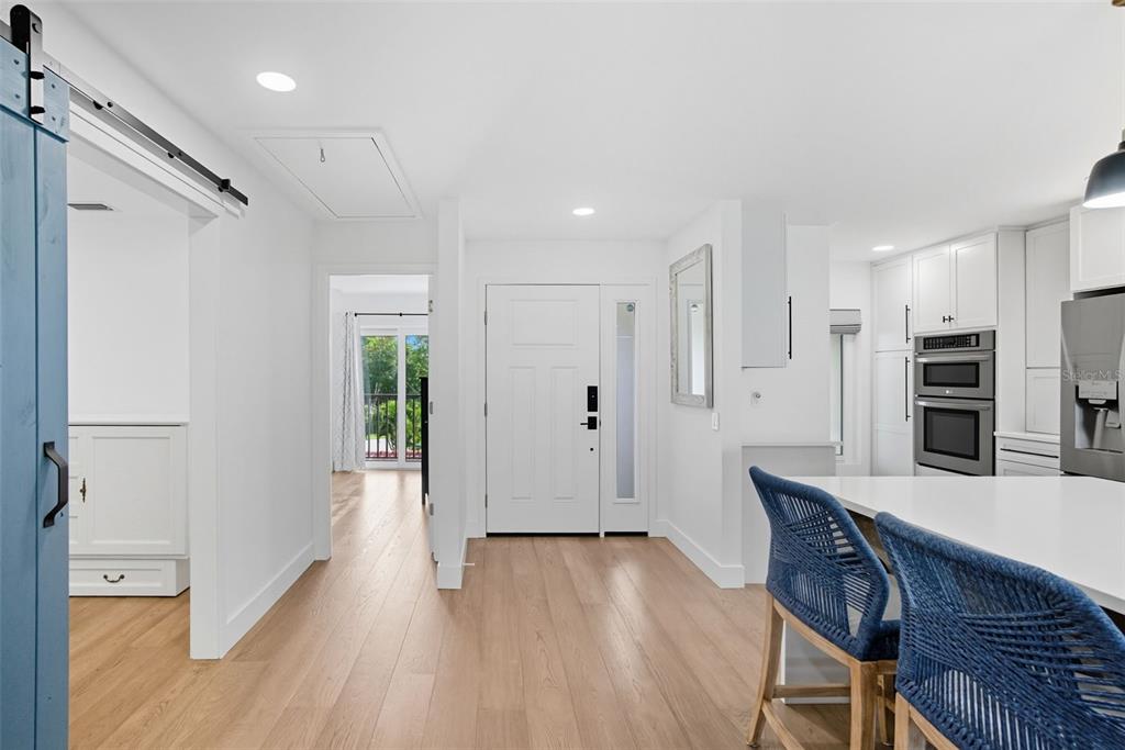 3420 Wild Oak Bay Boulevard, Unit 118 Bradenton, FL 34210 - Photo 10 of 40 a kitchen with stainless steel appliances a refrigerator and a wooden floor