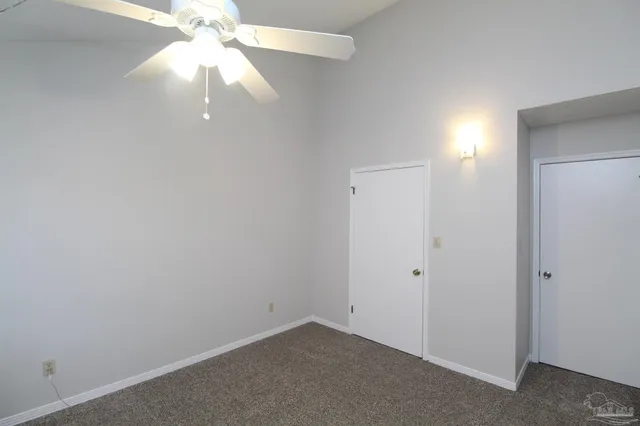 an empty room with a fan and a fan