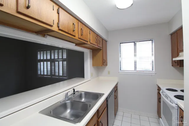 a kitchen that has a sink and a stove