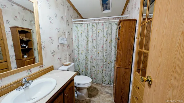 an empty room with wooden floor and a window