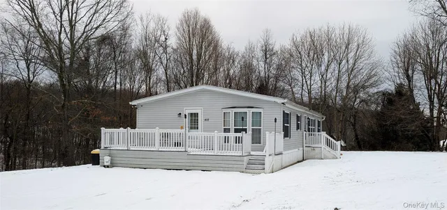 a view of a house with a yard covered in snow