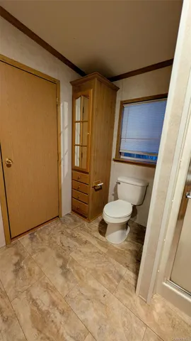 a bathroom with a toilet and a shower