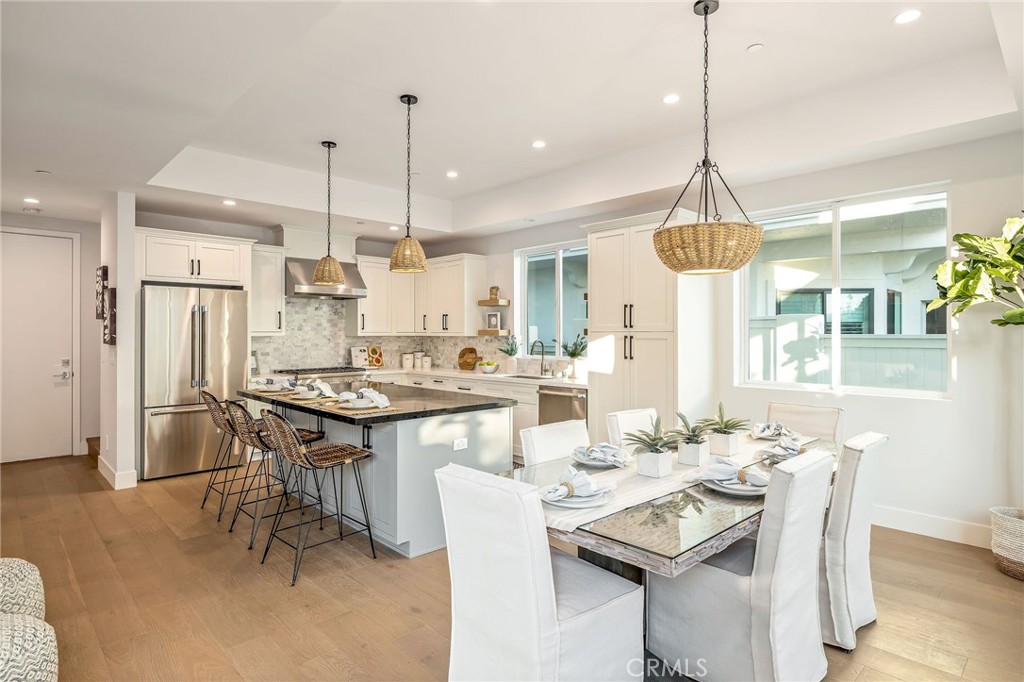 2016 Clark Lane, Unit B Redondo Beach, CA 90278 - Photo 10 of 31 a kitchen with stainless steel appliances kitchen island granite countertop a dining table and chairs