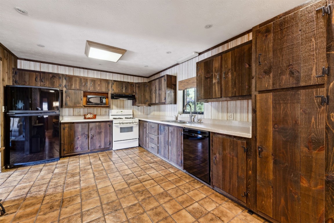 96111 Pirates Bluff Road Yulee, FL 32097 - Photo 15 of 52 a kitchen with stainless steel appliances a sink and cabinets