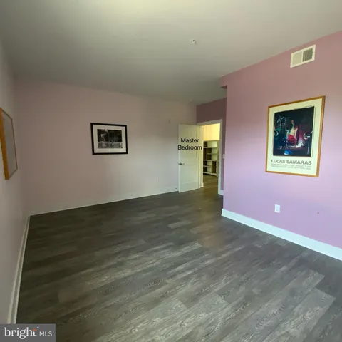 a view of room with window and wooden floor