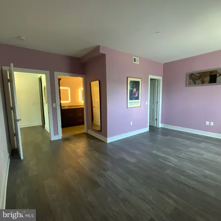 a view of a kitchen with a sink and dishwasher with wooden floor