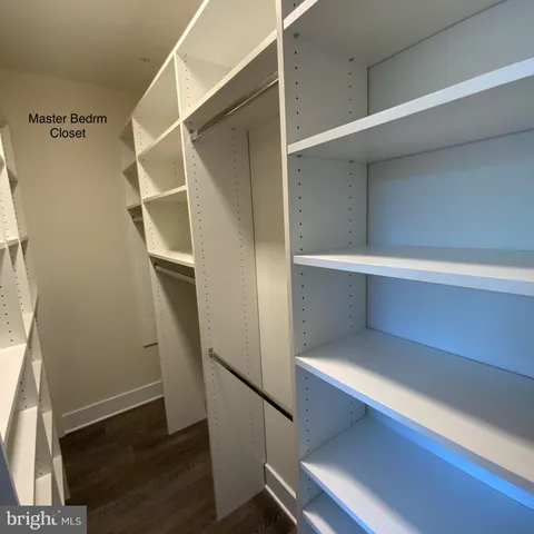 an empty room with wooden floor and a window