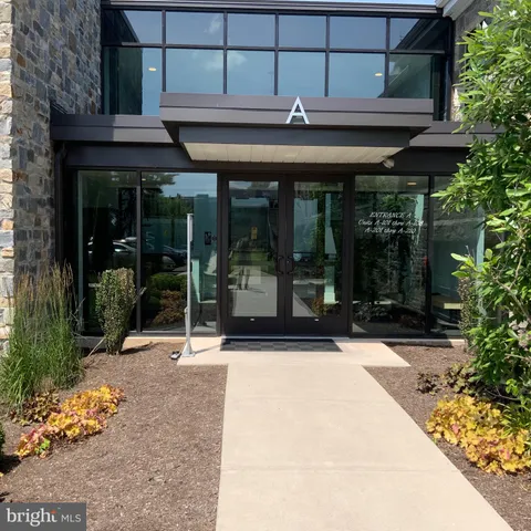 a view of a house with sitting area and glass windows